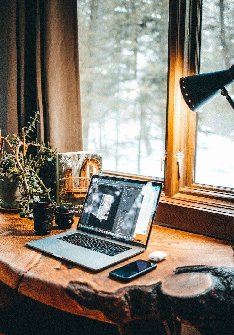powered-on desk lamp near laptop computer