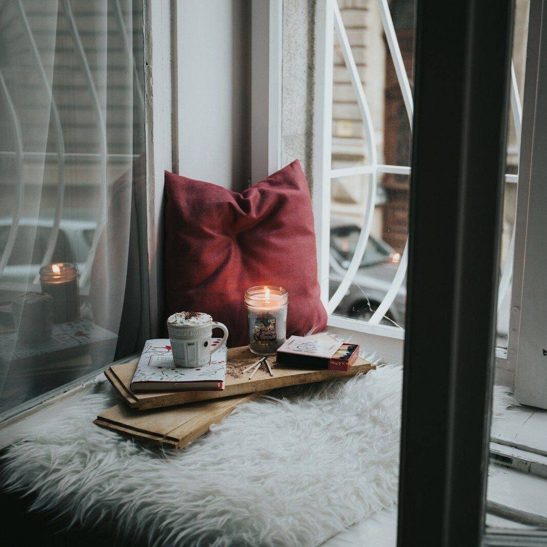 photo of gel candle on board beside pillow